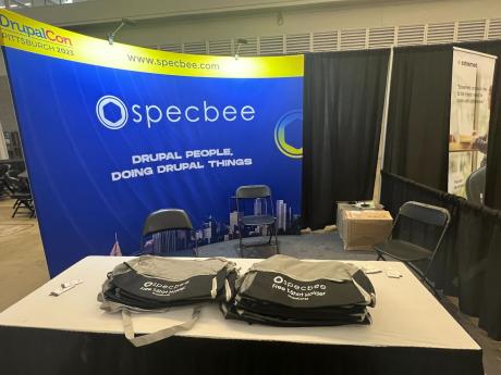 Specbee's Booth at DrupalCon Pittsburgh 2023 with Free GymBags to Distribute as Drupal Swag