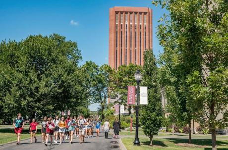 students running in front of UMass Amherst