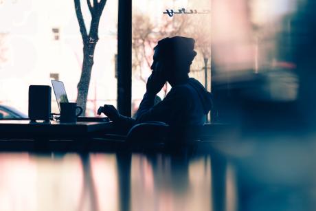 a person looking at laptop in a cafe