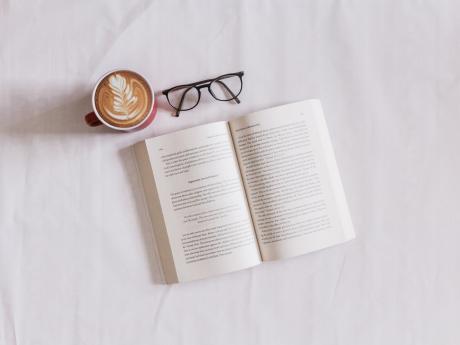 A book, cup of coffee and a spectacle