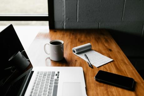 laptop, coffee cup and open book