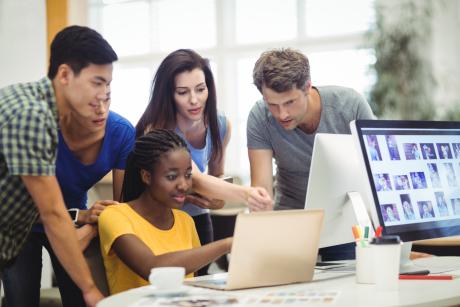 graphic designers discussing over laptop