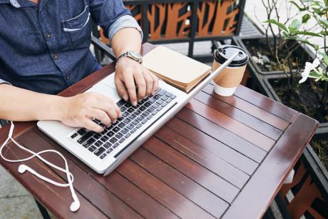 man coding on laptop