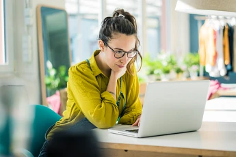 woman reading from her laptop