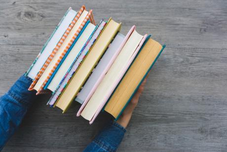 Top view of hands with books