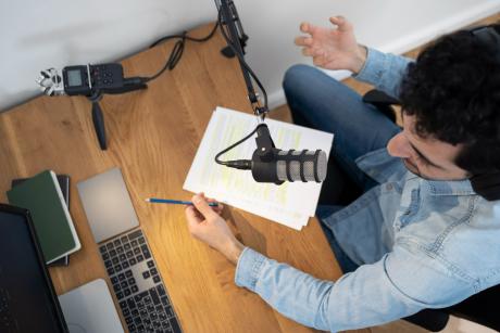 Man with microphone and headphones running a podcast in the studio