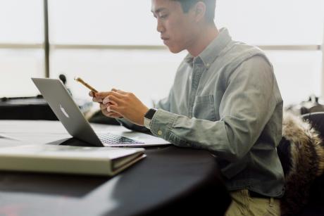 a-man-sitting-in-front-of-a-laptop-computer