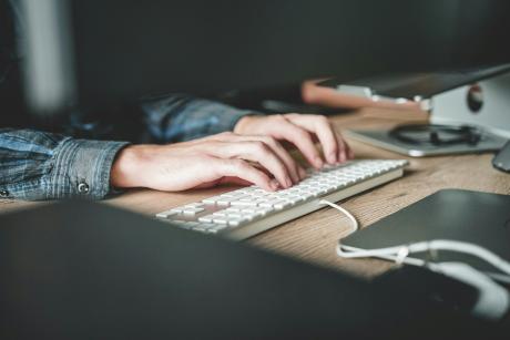 Person typing on keyboard