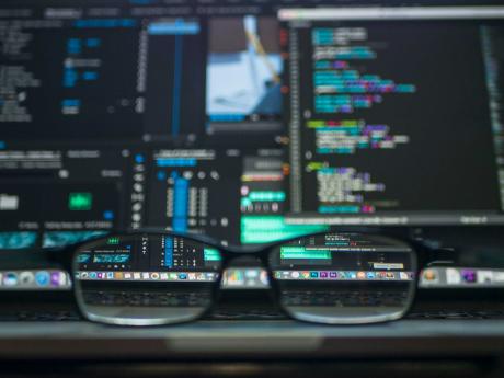 A blurred workstation focused through a reading glass. Photo: Kevin Ku