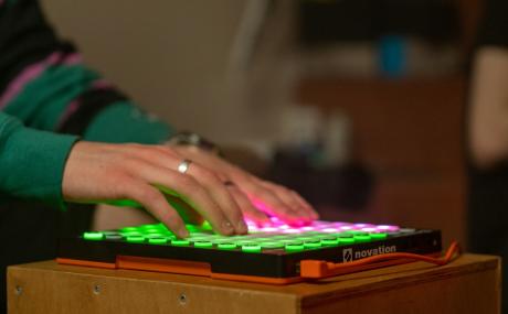 some guy typing on an illuminated keyboard