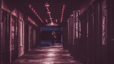 Person walking through a red-lit entry.