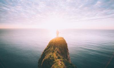 man standing on a cliff
