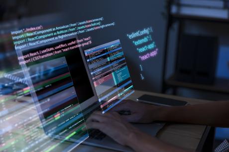 Programming background with person working with codes on computer