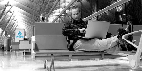 man with laptop in airport