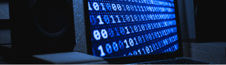 A security-themed image featuring a laptop screen displaying rows of blue binary code, symbolizing the digital threat landscape associated with incomplete software patching.