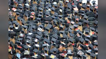 A see of college graduates at the commencement ceremony.