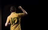 a person wearing Yellow coloured No. 10 jersey photographed from back