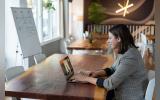 Women working on silver Macbook