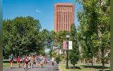 students running in front of UMass Amherst