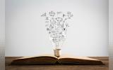 Symbols come out of a bulb on top of a book