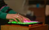 some guy typing on an illuminated keyboard