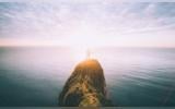 man standing on a cliff
