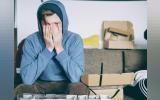 stressed man covering his face