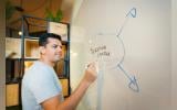 Man writing Marketing Strategy on White board