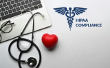 A laptop, stethescope, a red heart and HIPAA Compliance